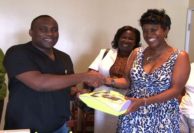 Medical Chief of Staff at the Alexandra Hospital Dr. John Essien presented with a portable defibrillator for the Health Facility by Mrs. Joan Broadbelt Robinson aka Keisha St. John, through her daughter Ms. Jewel Broadbelt on behalf of the Broadbelt, Queeley and Welcome families